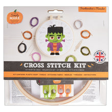 Load image into Gallery viewer, Simply Make Cross Stitch Kit featuring a Frankenstein's Monster design, packaged in a clear plastic sleeve with a wooden hoop showing the stitched design and thread spools visible around it.
